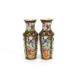 A pair of 19th Century Chinese Canton baluster vases, decorated with interior scenes, exotic