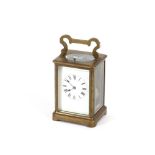 A brass cased striking carriage clock, with repeat button and angular swing handle, 17cm high
