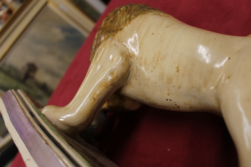 A 19th Century Staffordshire lion figure, right paw resting on a ball, 34cm long - Image 10 of 14