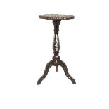 A carved Middle Eastern hardwood occasional table, with mother of pearl decoration, raised on a