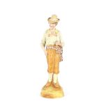 A late 19th  Century German porcelain figure, of a young man holding a rose, 38cm high