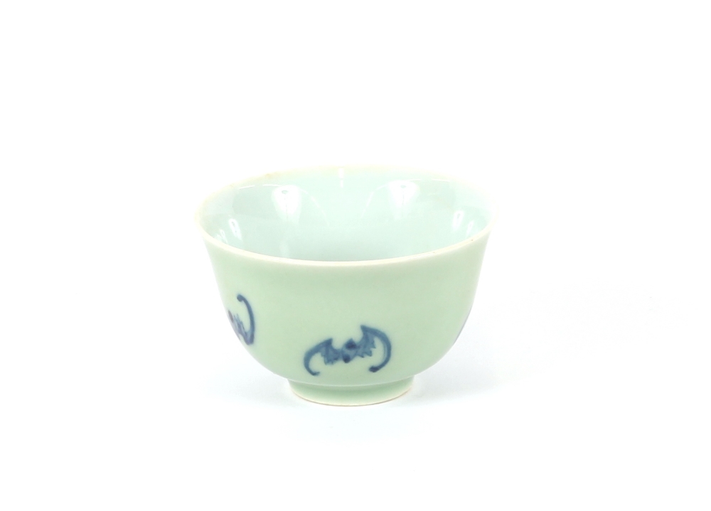 A small oriental celadon ground bowl, decorated with bats, character mark to base, 9cm dia.