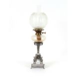 A Victorian plated table oil lamp, having fluted baluster column supported on mythological scrolling