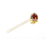 An 18 carat gold fox head stick pin, with Intaglio crystal decoration