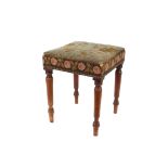 A Victorian mahogany dressing stool, with needlepoint upholstery, raised on turned tapering supports