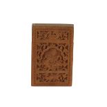 A finely carved 19th Century Indian sandalwood card case, decorated with deities, birds and foliage,