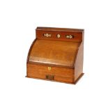 A Victorian golden oak stationery cabinet, enclosed by a tambour shutter front, integral calendar,