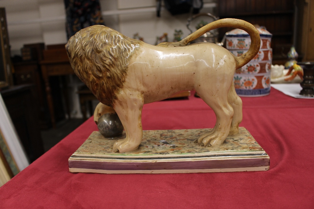 A 19th Century Staffordshire lion figure, right paw resting on a ball, 34cm long - Image 7 of 14