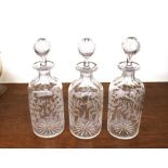 Three etched glass decanters, Brandy, Gin and Whisky