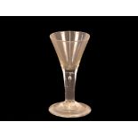 An Antique wine glass, having conical shaped bowl, raised on tear drop stem and circular spread
