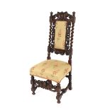 An Antique carved oak hall chair, having mask and foliate scroll decorated back within barley