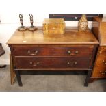 A George III mahogany chest, fitted two long drawers within canted reeded styles and raised on