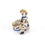 A small faience ware salt, depicting a seated gentleman with vine hod, brightly coloured, 9cm high