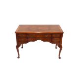 An 18th Century style walnut low boy, fitted five drawers above a shaped apron, raised on cabriole