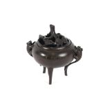 A Chinese bronze censer, of circular baluster form, with pierced lid, flanked by beast handles,