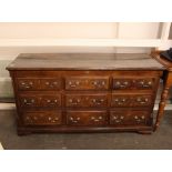 An 18th Century oak and mahogany cross-banded mule chest, fitted with an arrangement of dummy