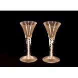 A near pair of Antique wine glasses, the conical shaped bowls raised on cotton twist stems and