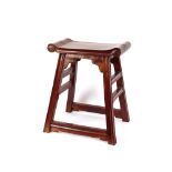 A Chinese hardwood stool, the scrolled curved top raised on square section supports, united by