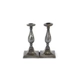A pair of 19th Century black metal and Niello work candlesticks, of baluster form, the white metal