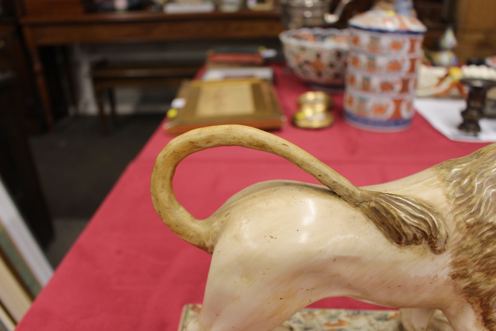 A 19th Century Staffordshire lion figure, right paw resting on a ball, 34cm long - Image 2 of 14