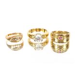 A ruby set 18 carat gold ring;  a three stone diamond set 18 carat gold ring and a large crystal