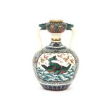 An oriental twin handled baluster vase, with dragon, flaming pearl and foliate decoration, 30cm