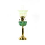 A Victorian brass column oil lamp, having opaque floral reservoir and Vaseline glass shade, 69cm