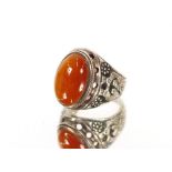 A large Cornelian set silver ring; and an amber and silver mounted ring, (2)