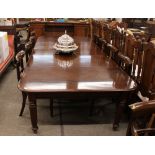 A mahogany extending dining table, fitted three extra leaves, raised on turned tapering fluted