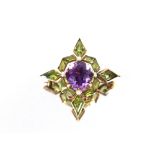 A amethyst and peridot set star shaped brooch, with yellow metal mount