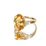 An Art Deco silver green stone ring; and a large citrine 9 carat gold mounted ring, size N, (2)