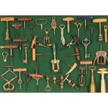 An interesting display of numerous Antique and later cork screws, and bottle openers