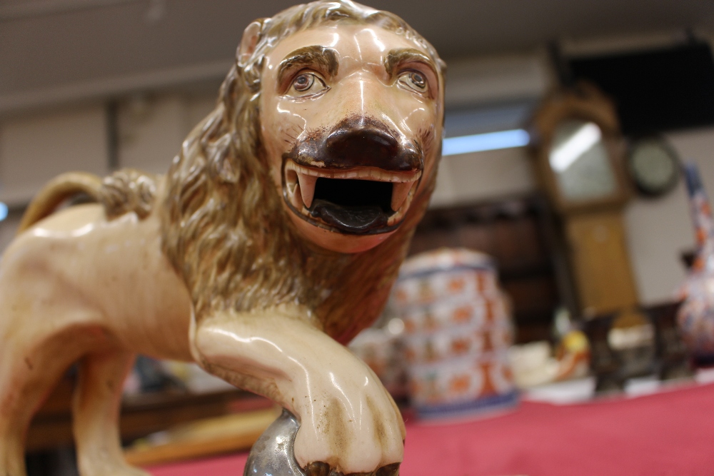 A 19th Century Staffordshire lion figure, right paw resting on a ball, 34cm long - Image 5 of 14