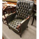 A 19th Century style mahogany library chair, upholstered in green buttoned leather, fold-out arm