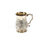 A George III silver baluster tankard, having foliate scroll decoration, later chased and