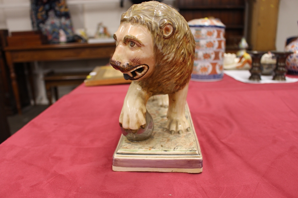 A 19th Century Staffordshire lion figure, right paw resting on a ball, 34cm long - Image 8 of 14