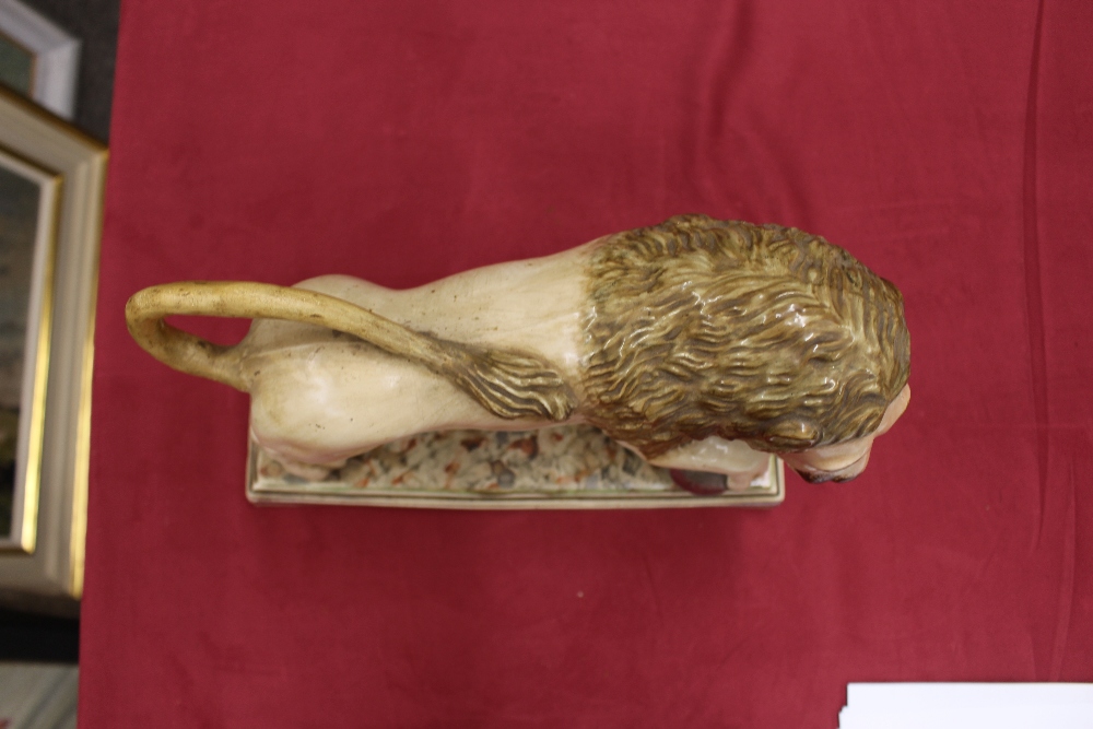 A 19th Century Staffordshire lion figure, right paw resting on a ball, 34cm long - Image 14 of 14