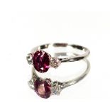 A diamond and ruby three stone ring