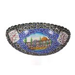 A Persian enamel and painted Kashkul, the boat shaped pierced body with centre panel depicting a