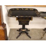 A 19th Century papier mache and lacquered work table, with tray top, drawer and silks well below,