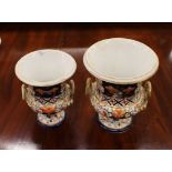 Two graduated 19th Century Derby campana shaped urns, decorated in the Imari palette