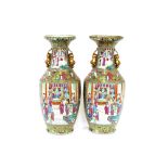 A pair of 19th Century Chinese Canton famille rose decorated baluster floor vases, decorated in