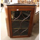 A George III  mahogany hanging corner cupboard, the shelves enclosed by a single glazed tracery