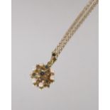 A 9 carat gold sapphire and pearl set pendant, hung to a 9 carat gold fine link chain