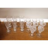 A set of six champagne flutes, and eight vine etched wine glasses, (14)