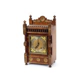 A late Victorian oak mantel clock, in architectural style case, with brass spandrel dial and steel