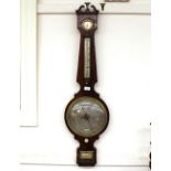 A 19th Century mahogany cased banjo wheel barometer, having silvered dials beneath a scroll arch