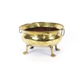 A 19th Century brass wine cooler, of elliptical form, flanked by ring handles, baluster body on