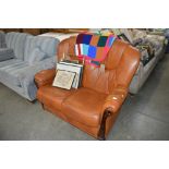 A leather upholstered two seater settee