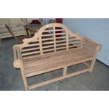 A teak roll top garden bench